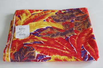 photo of soft cotton fabric w/ tropical palm leaves print in bold colors red, yellow, purple, brown