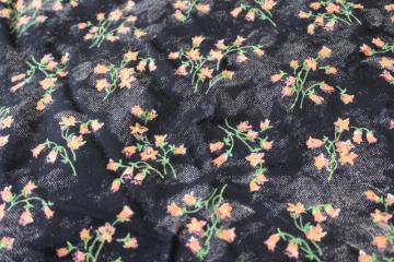 catalog photo of soft crinkle rayon / poly fabric, coral orange floral print on black, boho vintage