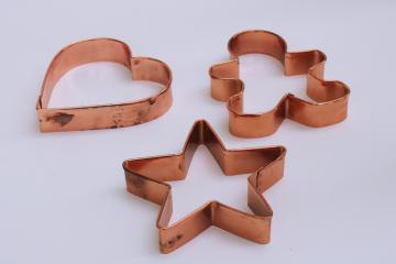 catalog photo of solid copper cookie cutters, large star, heart, gingerbread boy for traditional Christmas baking cookies