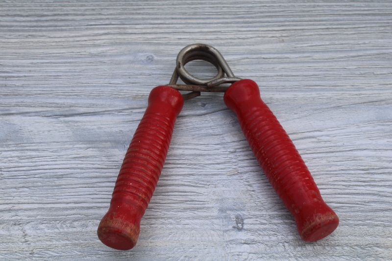 photo of squeeze grip hand strengthener w/ red painted wood handles, 1950s vintage fitness equipment #1