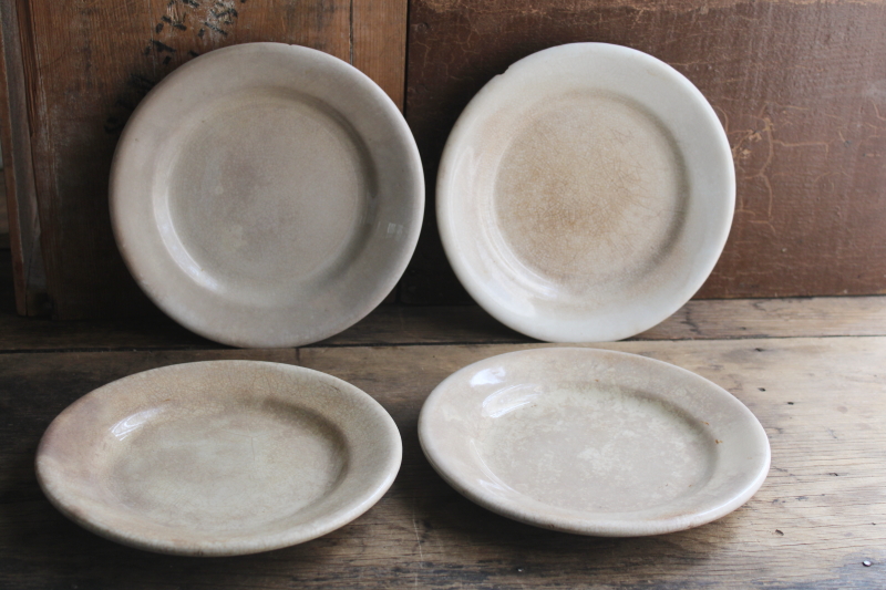 photo of stack of chunky antique English ironstone china plates, browned stained crazing patina  #1