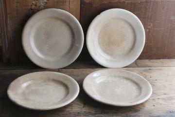 catalog photo of stack of chunky antique English ironstone china plates, browned stained crazing patina 