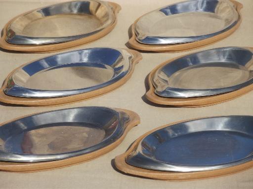 photo of steakhouse style sizzling steak plates, oval stainless platters w/ wood boards #1