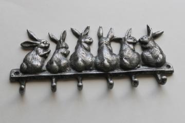 catalog photo of tiny bunnies vintage cast metal hooks, wall hanging rack for keys, garden tools, kitchenware 