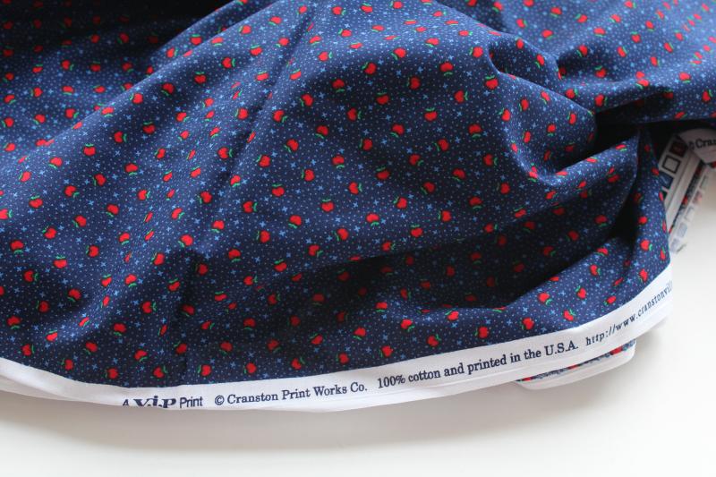 photo of tiny print quilting cotton fabric, red apples on navy blue marked VIP Cranston #1