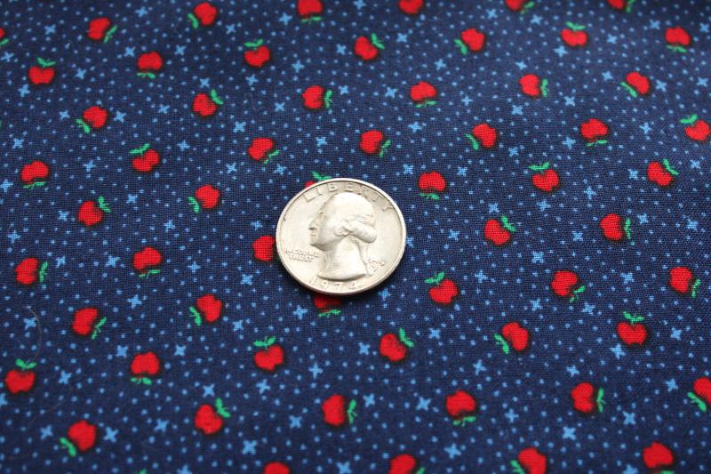 photo of tiny print quilting cotton fabric, red apples on navy blue marked VIP Cranston #2