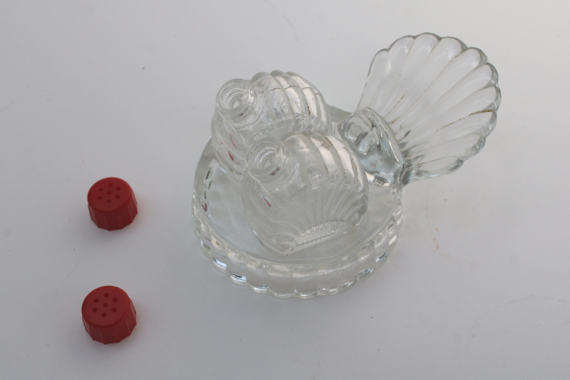 photo of tiny salt and pepper shakers in glass caddy tray, vintage clear glass S&P w/ red plastic lids #6