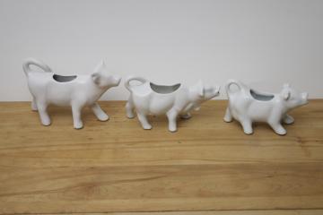 catalog photo of trio of ceramic cow creamers, plain white ironstone cream pitchers, french country modern farmhouse