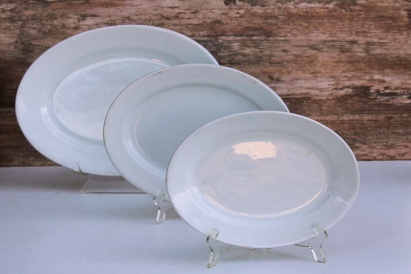 photo of trio of heavy white ironstone china platters vintage English backstamps, stack of chunky oval plates #1