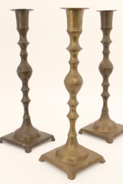 catalog photo of trio of vintage tarnished brass candle sticks, tall altar candlesticks