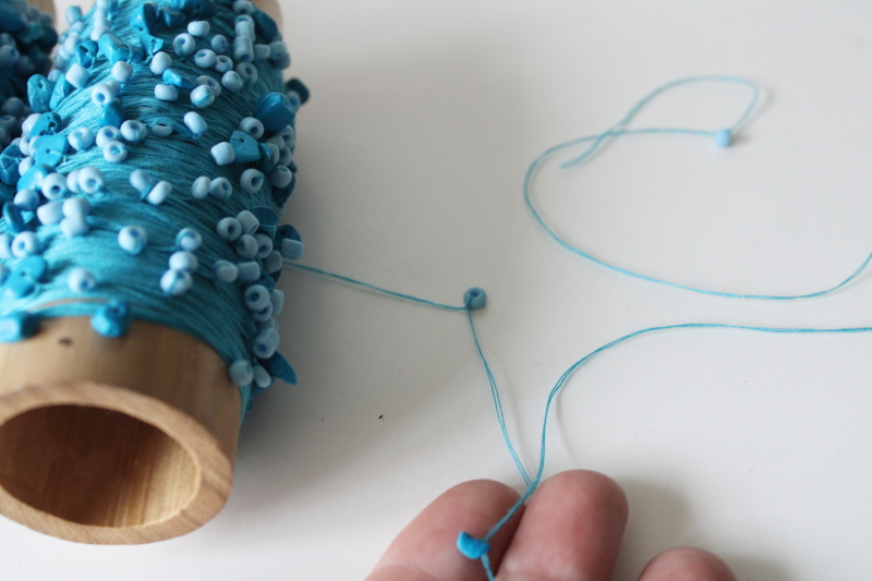 photo of turquoise glass seed beads threaded knotted on cotton crochet thread, hand beaded yarn  #3