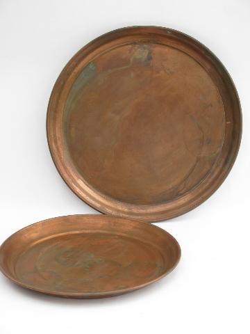 photo of two large round heavy solid copper trays, vintage West Bend #1