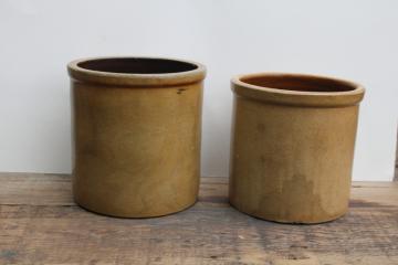 two old worn browned stoneware crocks, large planter pots for trees or greenery, farmhouse kitchen storage 