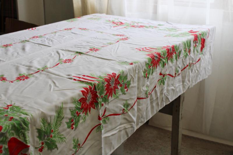 photo of vintage Christmas print tablecloth, rayon fabric w/ bells, candles, holly, poinsettias #1