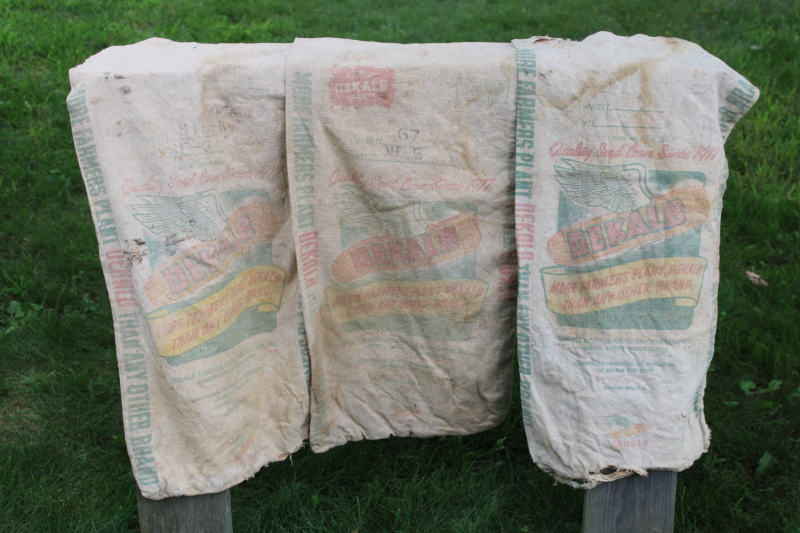 photo of vintage Dekalb advertising seed corn sacks, worn faded farm primitives, printed cotton grain bags  #1