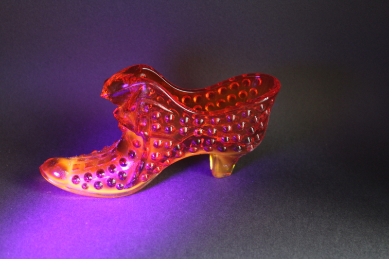 photo of vintage Fenton hobnail glass shoe, amberina red orange glass UV glow  #1