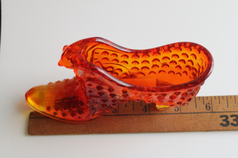 photo of vintage Fenton hobnail glass shoe, amberina red orange glass UV glow  #7