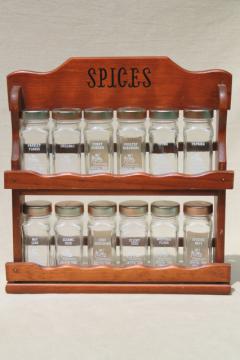 catalog photo of vintage Griffiths glass bottle spice set, 12 clear jars for spices & wood wall rack