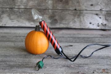 catalog photo of vintage Halloween black & orange striped cardboard candle, electric light for jack-o-lantern pumpkin