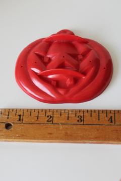 catalog photo of vintage Halloween cookie cutter, scary devil face jack o lantern pumpkin red plastic 