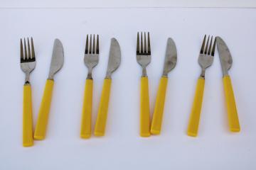 catalog photo of vintage Hong Kong stainless steel forks & knives, bakelite look yellow plastic handles flatware