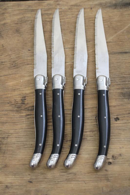 photo of vintage Laguiole France steak knives set of four, black plastic handles w/ bee #6