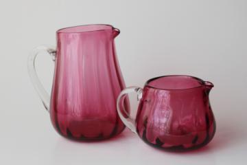 catalog photo of vintage Pilgrim hand blown cranberry glass, two small pitchers w/ clear glass handles