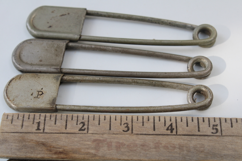 photo of vintage Risdon key tags, giant safety pins w/ old patent numbers, worn patina nickel plated brass #3