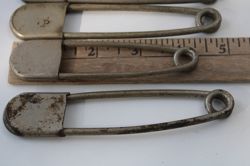 photo of vintage Risdon key tags, giant safety pins w/ old patent numbers, worn patina nickel plated brass #4