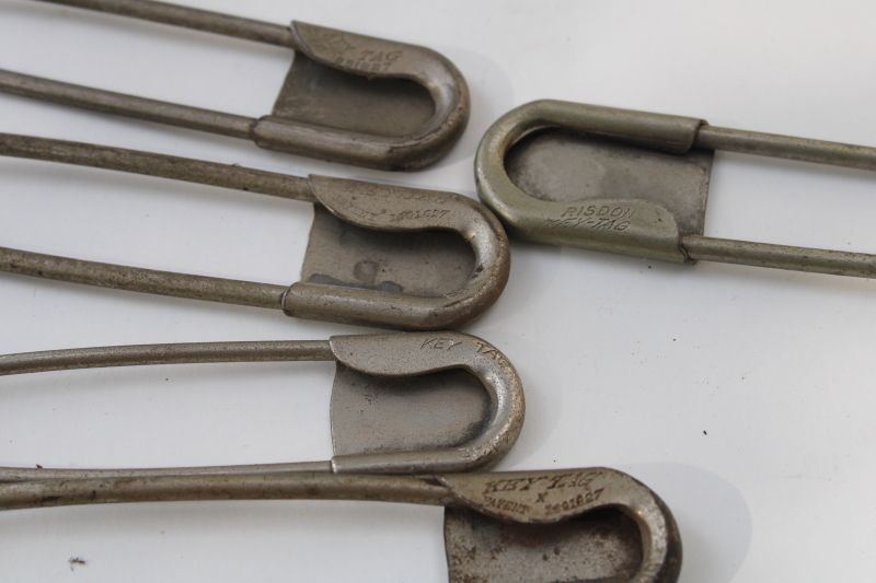 photo of vintage Risdon key tags, giant safety pins w/ old patent numbers, worn patina nickel plated brass #6