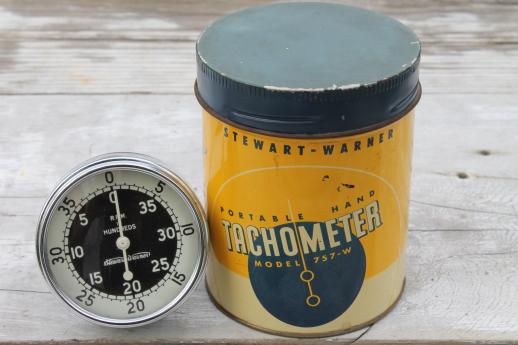 photo of vintage Stewart Warner 757W hand tachometer in tin case, 1940s garage or racing pit #1