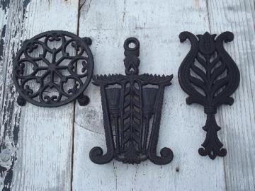 catalog photo of vintage Wilton cast iron kitchen trivets, round and iron shape trivet lot