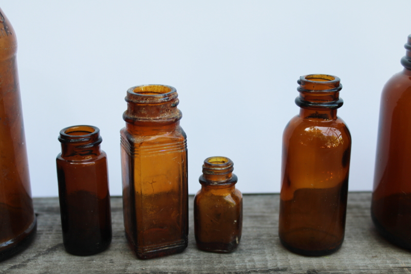 photo of vintage & antique root beer brown glass bottles, lot of old amber glass medicine bottles #2