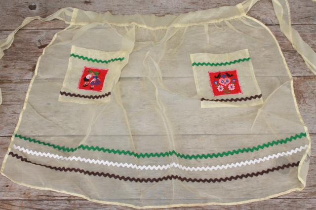 photo of vintage apron lot, kitchen aprons all retro fabric, pretty prints in yellow, green, blue #9