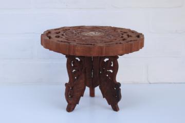 catalog photo of vintage boho decor, carved wood mini table plant stand made in India, trivet top w/ folding base