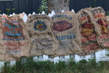 catalog photo of vintage burlap bags, mixed lot old potato sacks w/ colorful farm print graphics