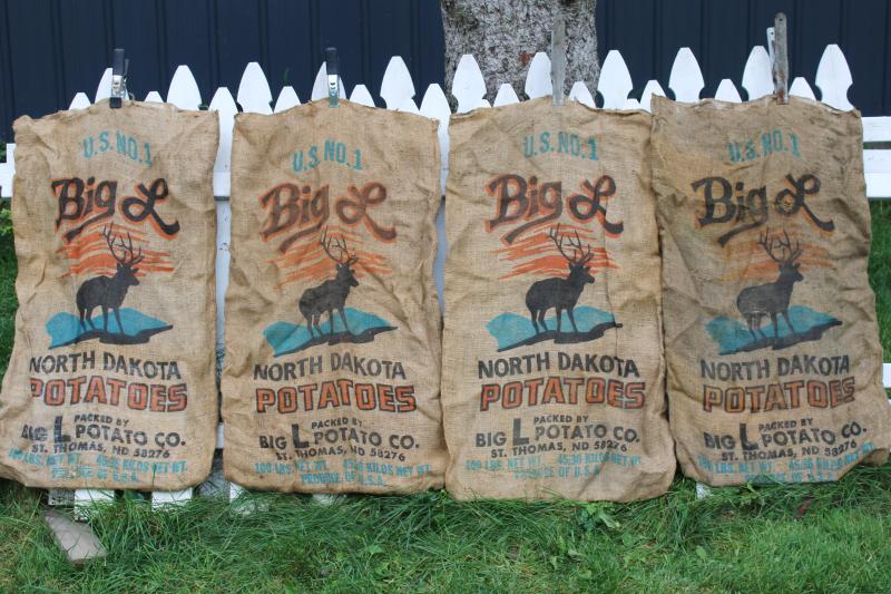 photo of vintage burlap bags, old potato sacks w/ print graphics Big L buck deer silhouette #1