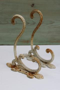 catalog photo of vintage cast iron hooks, large ornate wall mount plant hangers or coat hooks w/ old white paint 