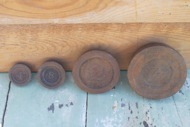 photo of vintage cast iron scale weights, antique numbered graduated rounds ounces & pounds #1