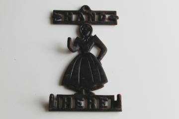 catalog photo of vintage cast iron wall hanging hook Hang Here Pennsylvania Dutch country Amish girl 