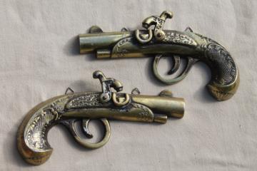 catalog photo of vintage cast metal wall plaques, wild west flintlock pistols wall art retro decor