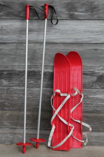 photo of vintage child's size skis, red plastic mini-ski set w/ poles, winter sport toy #1