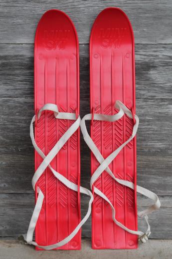 photo of vintage child's size skis, red plastic mini-ski set w/ poles, winter sport toy #2