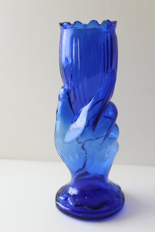 photo of vintage cobalt blue glass vase, lady's hand holding trumpet shaped flower #2