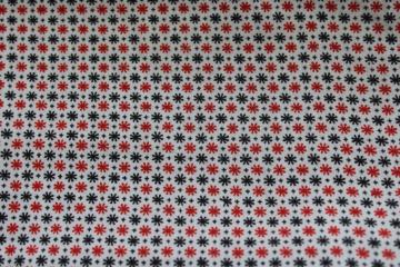 catalog photo of vintage cotton fabric, mid-century mod starbursts tiny print red & black on white