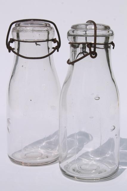 photo of vintage cream or milk bottles, old half-pint bottle w/ wire bail glass lids #1