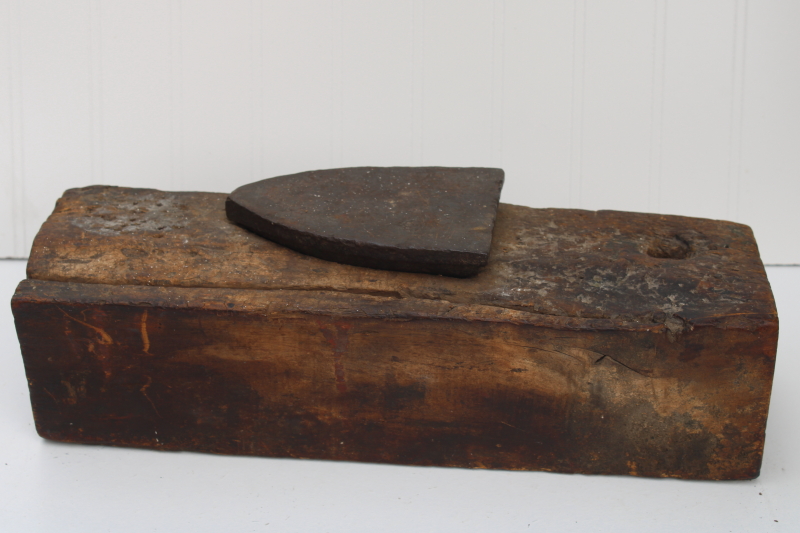photo of vintage depression era make do anvil, antique clothes iron set in a large old wood barn beam #5