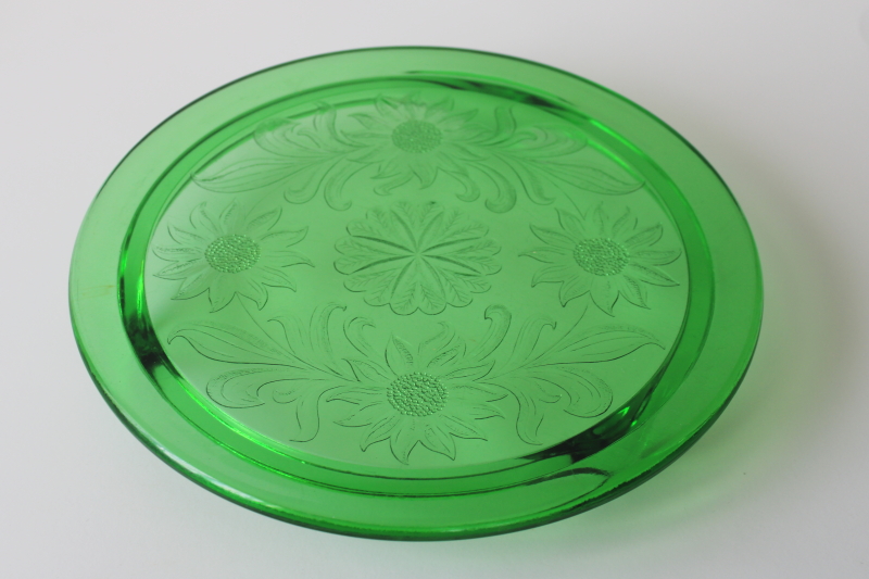 photo of vintage depression glass cake plate, Jeannette sunflower pattern deep green glass with uranium glow  #1