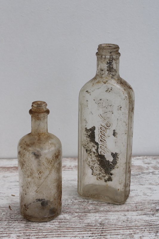 photo of vintage embossed glass medicine bottles, spooky old dug bottles for creepy haunted Halloween #1