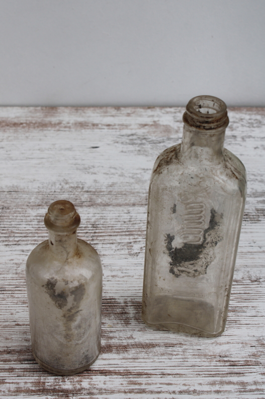 photo of vintage embossed glass medicine bottles, spooky old dug bottles for creepy haunted Halloween #4